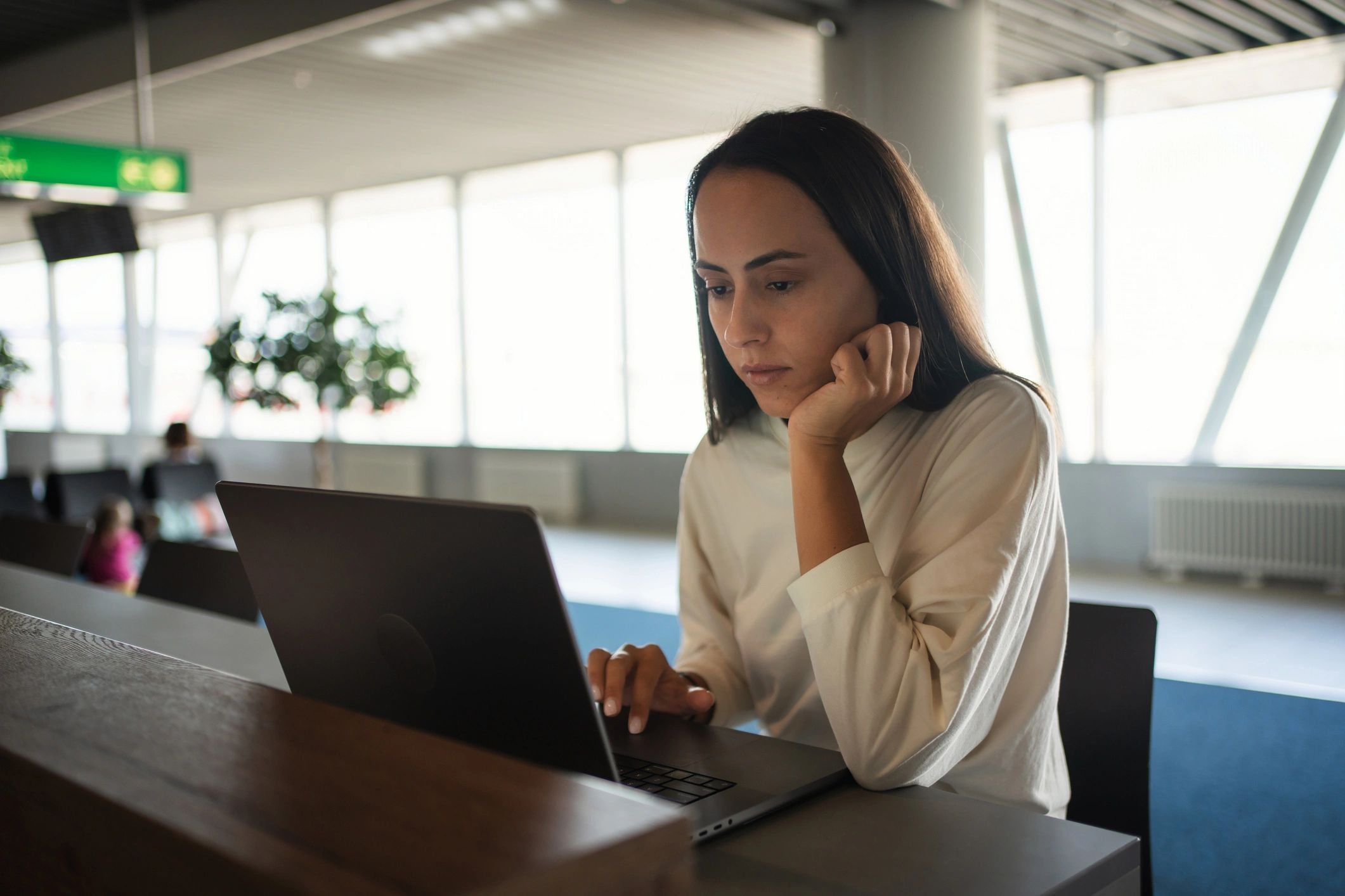 Travel planning on a laptop while preparing for a trip