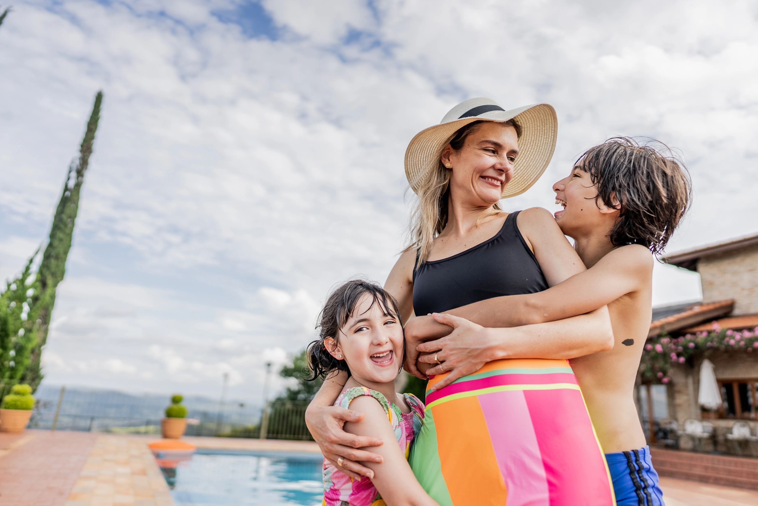Mother and children embracing at a resort hotel